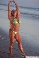 Amazing Muscle Babe posing outdoors