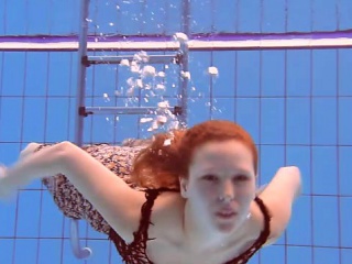 Redheaded Katka playing underwater